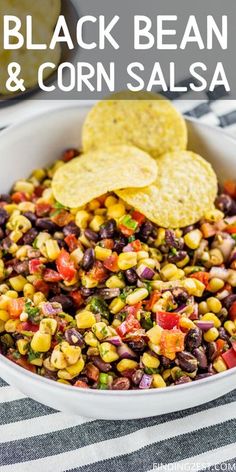 black bean corn salsa in a white bowl with tortilla chips on the side