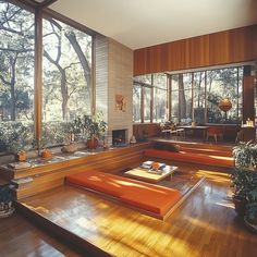 a living room filled with lots of furniture and large windows covered in wood paneling