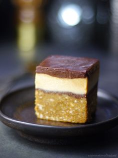 a piece of cake sitting on top of a black plate