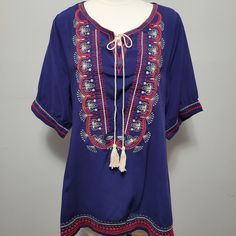 Effortless And Chic, The Perfect Pairing For Your Favorite Jeans Or Leggings. Blue With Red Embroidery Tassel Tie Tunic. Size Large 20" Bust 29" Length 100% Cotton Dry Clean Blue Bohemian Tops With Tassel Ties, Blue Bohemian Top With Tassel Ties, Blue Beach Tops With Tassels, Blue V-neck Tops With Tassels, Bohemian Blue Tops With Tassel Ties, Blue V-neck Top With Tassels, Beach Blue Tops With Tassels, Blue Tassel Tops For Beach, Bohemian Blue Top With Tassels