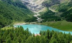 a lake surrounded by trees in the mountains