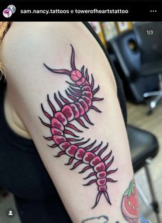 a woman with a black and red tattoo on her arm