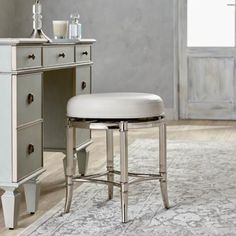 a white stool sitting in front of a vanity