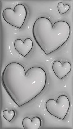 some white hearts are in the shape of heart shapes on a cookie sheet, and there is