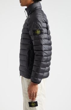 "Find STONE ISLAND Quiilted Nylon Down Puffer Jacket on Editorialist. A detachable compass badge affixed to the left arm adds the Italian label's signature touch to a channel-quilted puffer jacket insulated with ultraplush down. 25\" length (size Small) Two-way front-zip closure Stand collar On-seam zip pockets Lined, with duck down fill 100% nylon Made in Vietnam Designer Clothing" Designer Nylon Outerwear For Outdoor, Outdoor Nylon Outerwear With Logo Patch, Fall Nylon Outerwear With Logo Patch, Nylon Outerwear With Logo Patch For Outdoor, Stone Island Shirt, Stone Island Jacket, Down Puffer Jacket, Color Block Jacket, Quilted Puffer Jacket