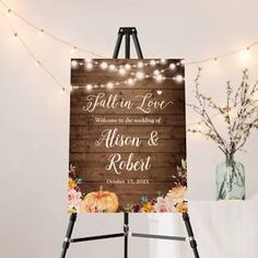 an easel with a sign on it that says fall in love