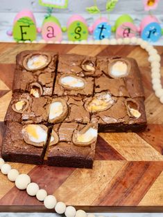 some brownies are cut into squares on a cutting board with eggs and marshmallows