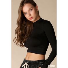 Seamless crop top featuring a mock neckline, long sleeves, and a form-fitting silhouette. One size 92% Nylon, 8% Spandex Made in the USA Seamless Crop Top, Mock Neck Crop Top, Black Mock Neck, Black Seamless, Swimwear Dress, Ribbed Crop Top, Cute Jackets, Mock Neck Top, Mock Neckline