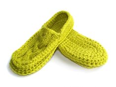 two crocheted slippers sitting on top of each other