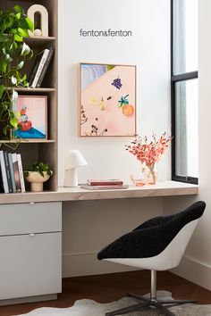 an office with a desk, chair and bookshelf in it's corner