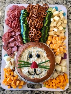 a platter filled with cheese, crackers and pretzels