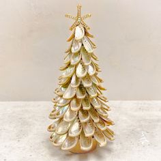 a small christmas tree made out of seashells