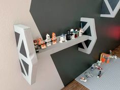 a lego star wars scene is displayed on the wall next to a shelf with toys