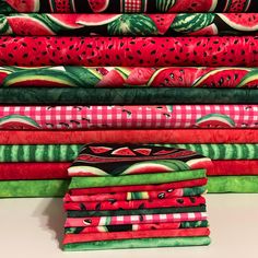 a stack of watermelon printed fabrics