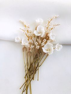 some white flowers are sitting on top of a piece of paper that is folded in half