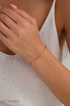 Discover the refined charm of our Dainty Gold Rectangle Link Bracelet Chain. ✨ This minimalist gold paperclip chain bracelet is designed for the modern woman who appreciates simple yet elegant jewelry. Featuring an Italian chain design, this bracelet adds a unique touch to any ensemble, making it perfect for any occasion. Its versatile style effortlessly complements both casual and formal looks, making it a must-have accessory for anyone who loves chic and sophisticated jewelry Classic Paperclip Bracelet With Rectangular Gold Links, Timeless Gold Paperclip Bracelet With Rectangular Links, Gold Paperclip Bracelet With Adjustable Chain And Rectangular Links, Dainty Gold Rectangular Paperclip Bracelet, Minimalist 14k Gold Rectangular Paperclip Bracelet, Bracelets Gold Simple For Women, Gold Bracelet Simple, Paperclip Bracelet, Italian Chain