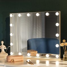 a vanity mirror with lights on top of it next to a vase and other items