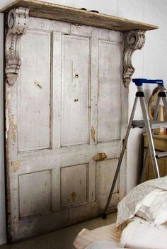 an old white painted door in a bedroom