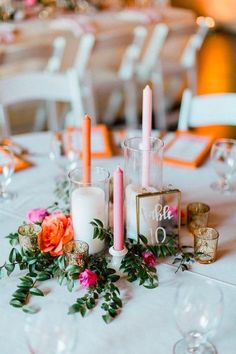 the table is set with candles, flowers and napkins for an elegant wedding reception