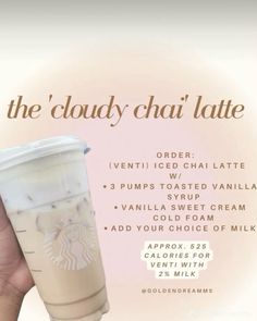 a hand holding a starbucks cup with the words, the cloudy chai latte