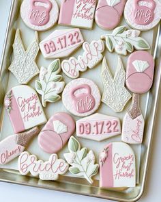 decorated cookies in pink and white on a tray