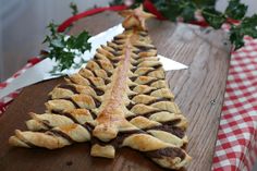 several pastries are lined up on a wooden table with christmas decorations in the background