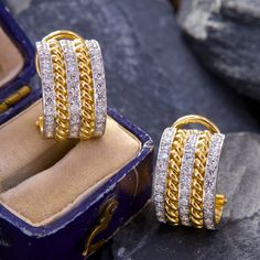 These dazzling clip-on Toni Cavelti designed earrings are each accented with three-rows of twelve (12) round brilliant cut diamonds bead set into platinum. The diamonds rows alternated with 18K yellow gold rope motifs. The earrings measure 16.3mm X 10.4mm and are finished with omega hinged backs. Signed CAVELTI 18K PLAT. Classic Clip-on Diamond Earrings, White Gold Clip-on Earrings With Diamond Accents, Anniversary Diamond Clip-on Earrings, Luxury Brilliant Cut Clip-on Earrings For Anniversary, Anniversary Diamond Clip-on Earrings Hallmarked, Diamond Hallmarked Clip-on Earrings For Anniversary, Anniversary Diamond Hallmarked Clip-on Earrings, Luxury Yellow Gold Clip-on Diamond Earrings, Classic Yellow Gold Diamond Clip-on Earrings