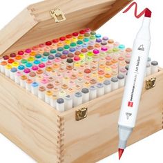 a wooden box filled with lots of different colored markers