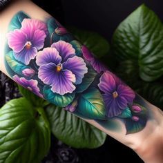 a woman's arm with flowers painted on it