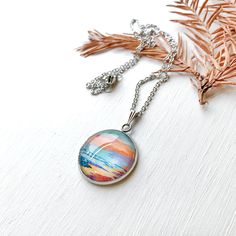 *These beautiful necklaces feature a print of one of my original paintings. *The image is glazed into a glass dome, which is attached to a metal pendant tray which measures approximately 1inch diameter. *Both the chain and the pendant bezel are made of stainless steel which means they won't change color or tarnish. *The chain is 20 inches long. Multicolor Cabochon Round Pendant Necklace, Multicolor Cabochon Necklace With Round Pendant, Artsy Nickel-free Necklace With Round Pendant, Artsy Silver Necklace With Round Pendant, Glass Dome, Steel Necklace, Metal Pendant, Glass Domes, Stainless Steel Necklace