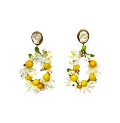 a pair of earrings with lemons, flowers and pearls on the end of them