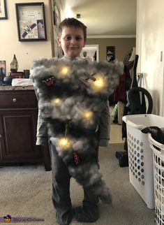 a young boy is dressed up as a man with lights on his chest and pants