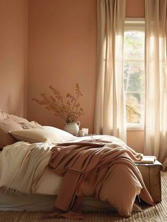 a bed sitting under a window in a bedroom