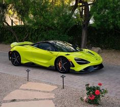 a yellow sports car is parked in the driveway