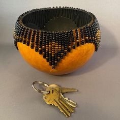 an orange with beads on it and a pair of keys