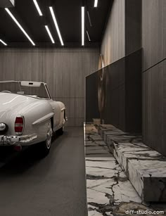 a white car is parked in an empty room with marble steps leading up to it