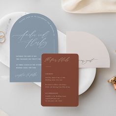 the wedding stationery is laid out on a plate