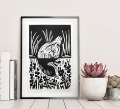 a black and white drawing of a fish in the water next to books on a shelf