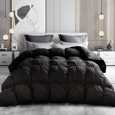 a bed with black comforter and pillows in a room