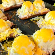 eggs are being cooked on toasted bread in a skillet with cheese and other toppings