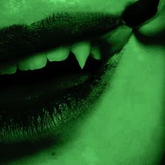 a woman's green lips with white teeth