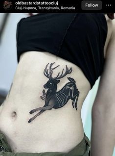 a woman with a deer tattoo on her stomach