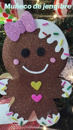 a christmas ornament with a ginger on it's face and pink bow