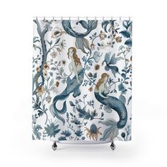 a shower curtain with mermaids and flowers on it