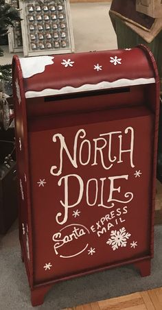 the north pole express mailbox is decorated with snowflakes and holiday writing on it