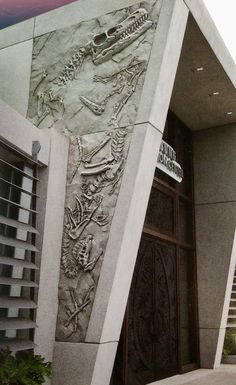 a building with a large door that has carvings on the outside and sides of it