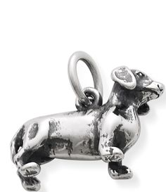 a silver dog charm on a white background