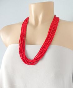 Yes, you have found the perfect red necklace. Size shown is 24". It is delicate but make a statement. The size of the beads is dainty but together they create a perfect flowing accessory. This is a  timeless red necklace made with the finest seed beads. One of our best sellers! You will get plenty of compliments . Also great for a Valentines Day gift or Christmas gift! The necklace has 9 strands and it's available with silver and gold clasp. Also, choose desired length at checkout. You can find Tiny Bead Necklace, Red Beaded Necklace, Red Beaded Necklaces, Christmas Gifts For Wife, Buy Necklace, Red Necklace, Jewelry Essentials, Valentines Necklace, Red Earrings