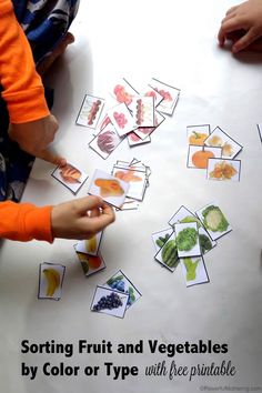 children are playing with fruits and vegetables by color or type printables on the table