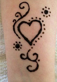 a tattoo with a heart and paw prints on it